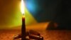 UKRAINE – Candles flag colors for remembering day dark background. Illustrative photo