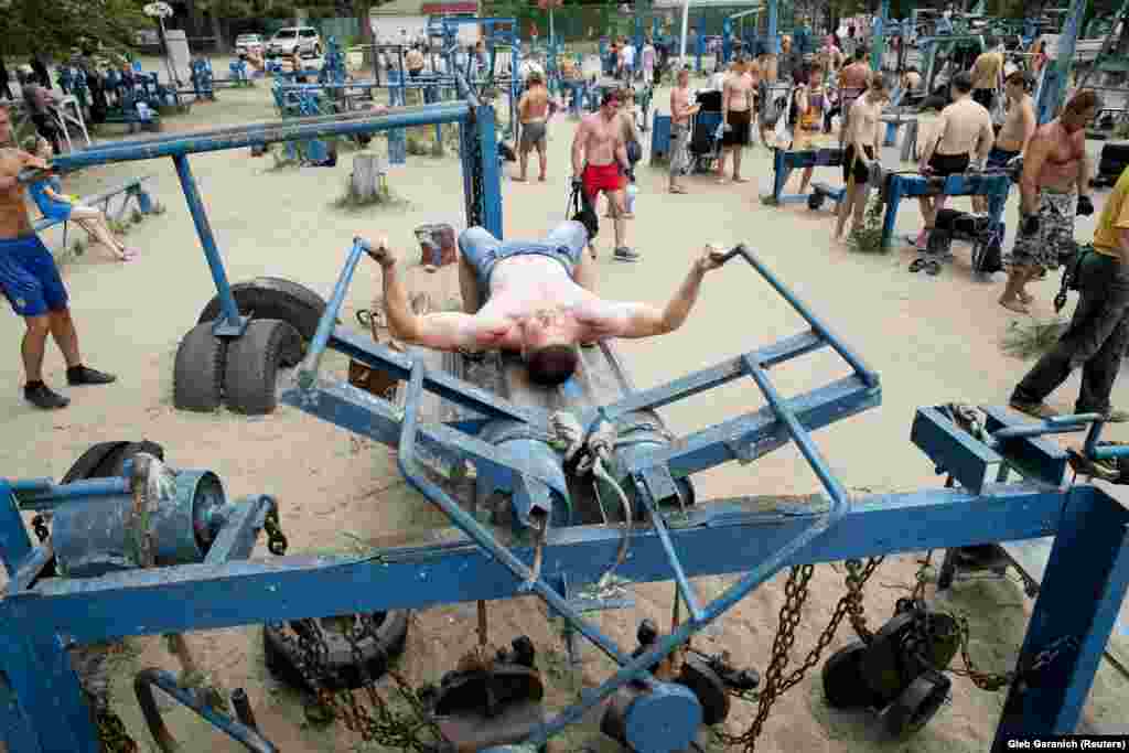 A young strongman grappling with a pec-deck.&nbsp;Yuri Kuk, one of the founders of the gym told the Associated Press &quot;We wanted people to have an active leisure time, not just play cards on the beach.&quot;