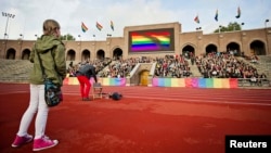 Demonstrators raise rainbow flags at Stockholm's Olympic Stadium during a protest over a controversial Russian law banning gay "propaganda." Some athletes attending the upcoming Winter Olympics in Russia have also pledged to denounce the legislation even though explicit political statements are forbidden by the Olympic Charter. 