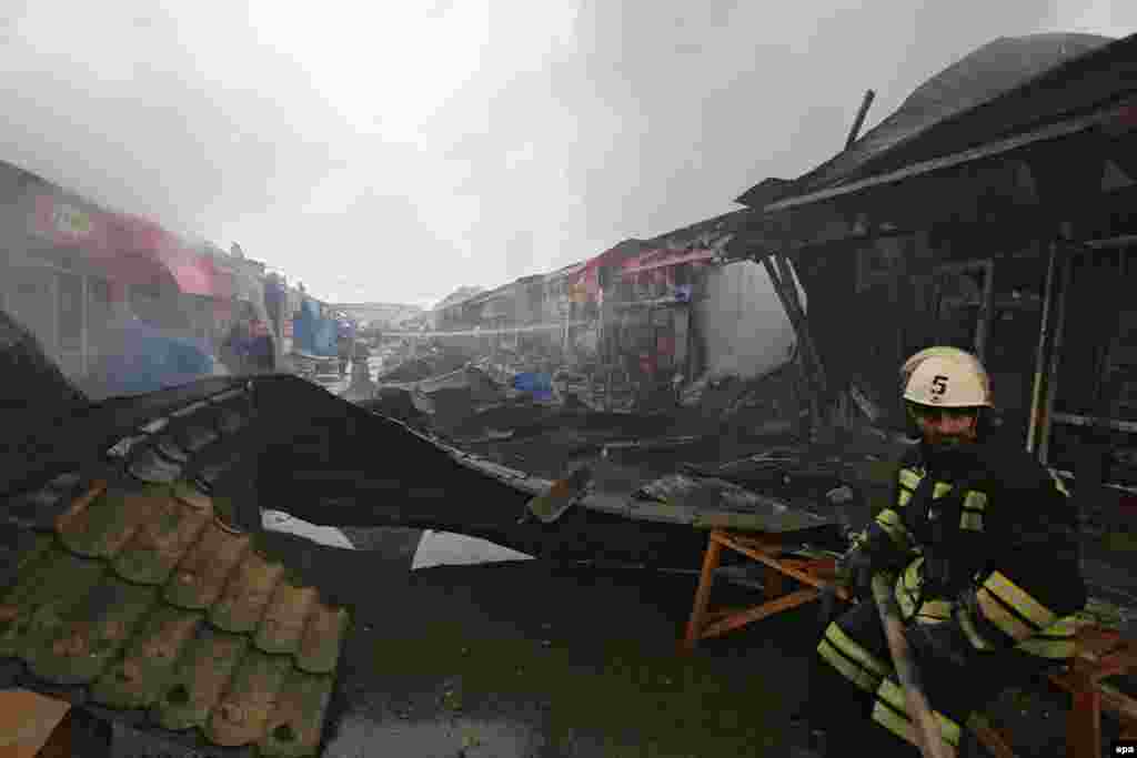 Firefighters work at a market set alight during a terrorist attack in Grozny, the capital of Chechnya, on December 4. At least 14 policemen and security force members and 10 militants were killed in gun battles during the attack. (Kazbek Vakhayev, epa)