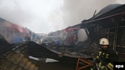 Firefighters work at a marketplace that was set on fire after a terrorist attack in Grozny on December 4.