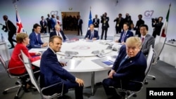 French President Emmanuel Macron and President Donald Trump participate in a G-7 Working Session on the Global Economy, Foreign Policy, and Security Affairs at the G-7 summit.