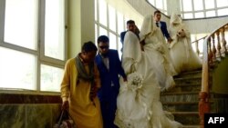 Afghan couples arrive for a mass wedding ceremony in the western city of Herat in May 2017