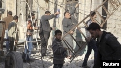 Banorët në një lagje të Alepos në Siri i riparojnë dëmet nga sulmet ajrore