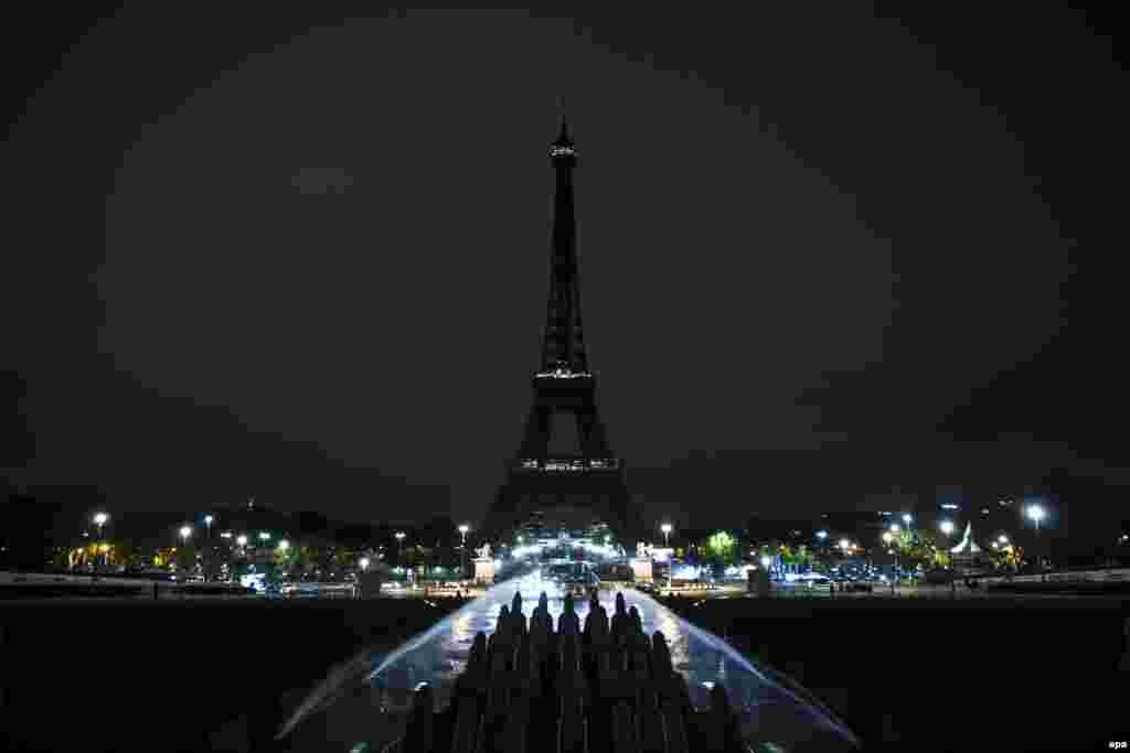 The lights of the Eiffel Tower are switched off as a mourning gesture after the shootings and bombings on November 13 in Paris. At least 129 people were killed in a series of attacks in what is Europe's worst terror attack since the Madrid train bombings in 2004. (epa/Etienne Laurent)