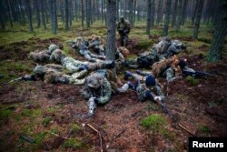 Participants secure a position during a territorial defense training organized by the Polish paramilitary group SJS Strzelec (file photo)