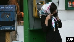 An Iranian woman veiled in a modern fashion talks on the phone in Tehran.