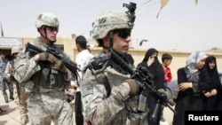 U.S. soldiers secure an area during a distribution of relief goods in Karbala, Iraq on August 11.