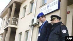 A Hungarian EULEX police officer (left) walks with his local counterpart in the Serbian enclave of Gracanica.