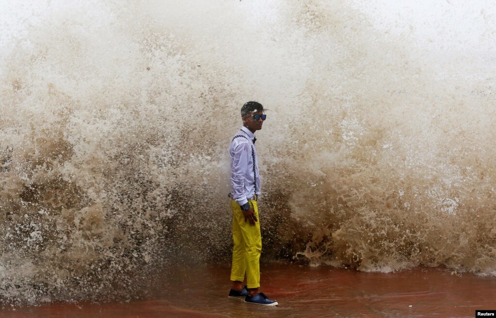 A boy poses for a photograph during high tide in Mumbai, India. (Reuters/Shailesh Andrade)