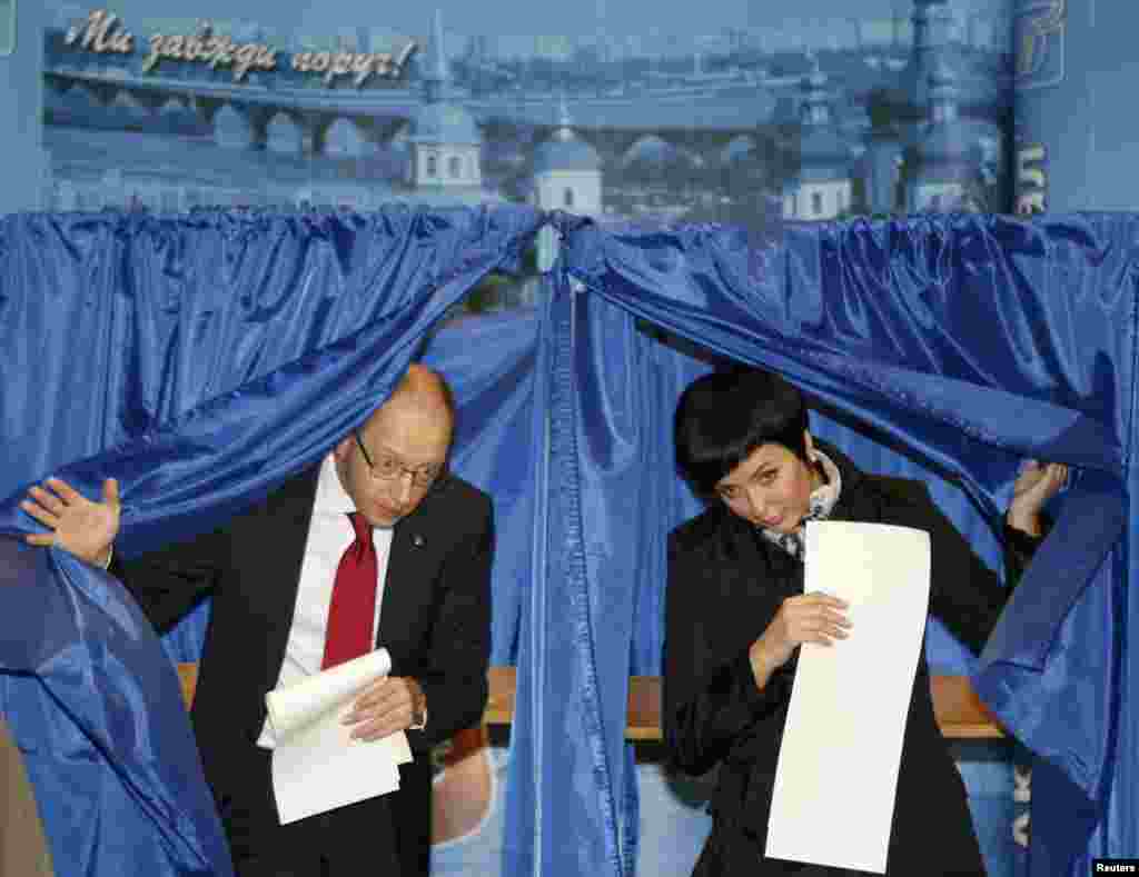 A former parliamentary speaker and candidate for president in 2010, United Opposition movement leader Arseny Yatsenyuk, and his wife Theresa vote in Kyiv.