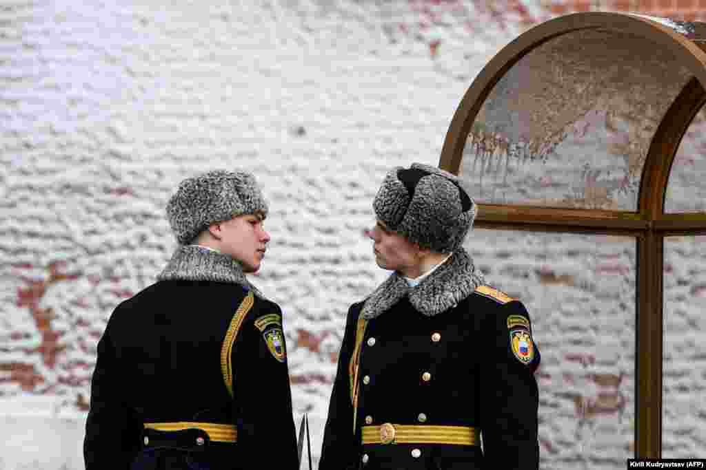 Russian servicemen look at each other during a changing-of-the-guards ceremony at the Tomb of the Unknown Soldier by the Kremlin wall in Moscow. (AFP/Kirill Kudryavtsev)