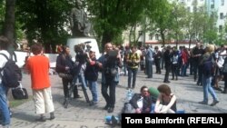 Protesters lie on camping mats in front of the statue of Abai in Moscow.