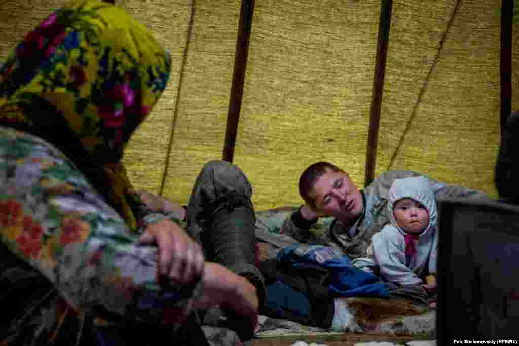 Vitaliy Multanov with his daughter Vitalina and his mother Lubov. This family resides in a district where the land has been leased to an oil company. 