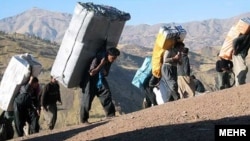 Bent under the weight of their loads -- smuggled cigarettes, alcohol, gasoline, and even home appliances -- the "mules" are a common sight in Iran's western border regions.