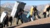 Kurdish porters cross the Iran-Iraq border. Small scale smuggling is done by sending porters across the border. File photo