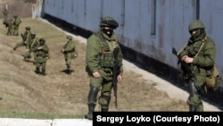 Russian soldiers in front of a Ukrainian military base in Crimea in March 2014
