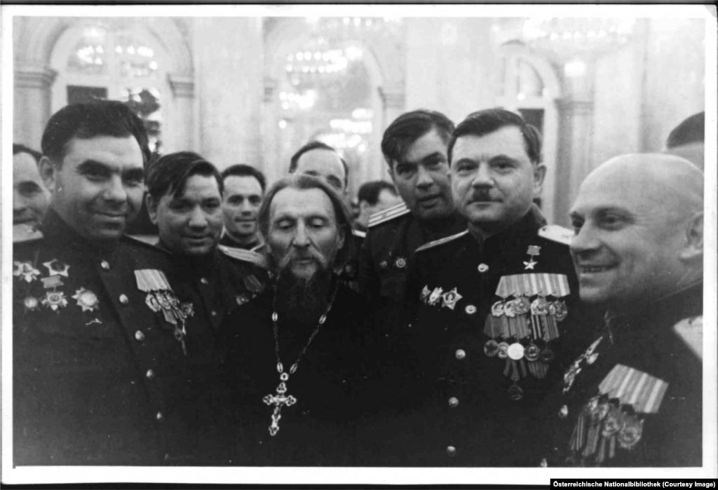 An Orthodox priest outblinged by a group of Soviet generals.