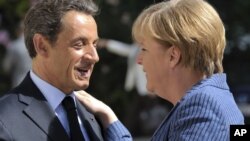 French President Nicolas Sarkozy (left) with German Chancellor Angela Merkel