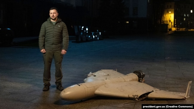 Ukrainian President Volodymyr Zelenskiy stands next to a downed Iranian-made Shahed-136 kamikaze drone in Kyiv on October 27, 2022.