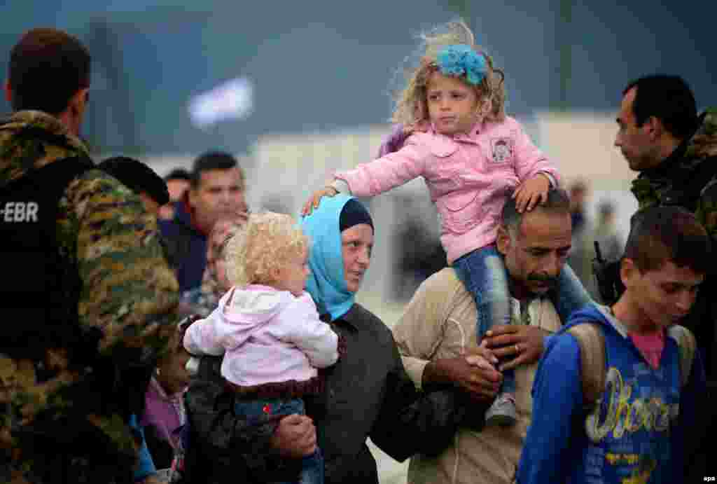 Migrants board a train after they crossed the border between Macedonia and Greece, near the town of Gevgelija, Macedonia. The Gevgelija-Presevo leg is just a part of the journey that the refugees, the vast majority of them from Syria, are forced to make along the so-called Balkan corridor, which takes them from Turkey, across Greece, Macedonia and Serbia. (epa/Nake Batev)