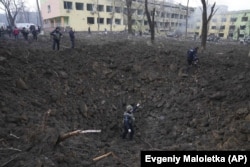 The massive crater left by the air strike at the hospital