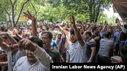 A group of protesters rally at the old Grand Bazaar in Tehran in June. 