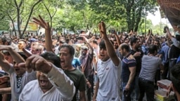 A group of protesters rally at the old Grand Bazaar in Tehran in June. 