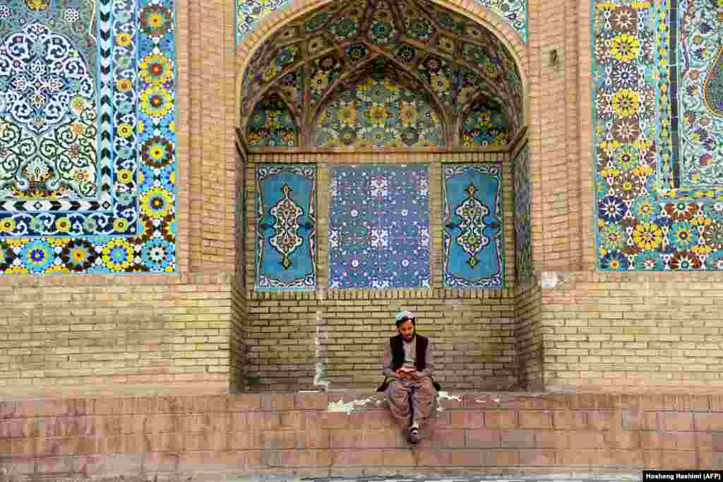 An Afghan Muslim reads the Koran outside a mosque during the holy month of Ramadan in Herat Province. (AFP/Hoshang Hashimi)