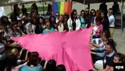 Rights activists of the LGBT community hold a pink triangle, a symbol used in Nazi concentration camps to identify gays and lesbians, on the occasion of the International Day Against Homophobia in Tirana on May 17.