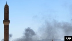 Smoke billows from a neighborhood in the Yemeni capital, Sanaa.