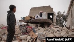 A Syrian boy looks at the rubble of the house where he had lived with his displaced family in the village of Kafr Taal, in Aleppo's western countryside, after a reported pro-regime bombardment on January 20.