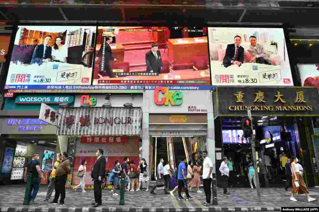 China's President Xi Jinping (top C) is shown on a large video screen in Hong Kong on May 28, 2020, during a live broadcast of the National People’s Congress (NPC) in Beijing. China's parliament approved plans on May 28 to impose a security law on Hong Kong that critics say will eradicate the city's promised freedoms. (Anthony WALLACE / AFP)