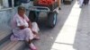 Turkmenistan. women sits at road-side