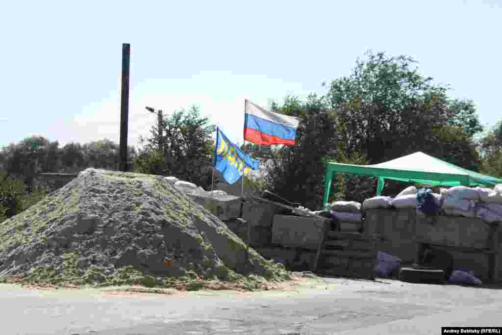 Near the city of Luhansk, pro-Russian separatists man a checkpoint.