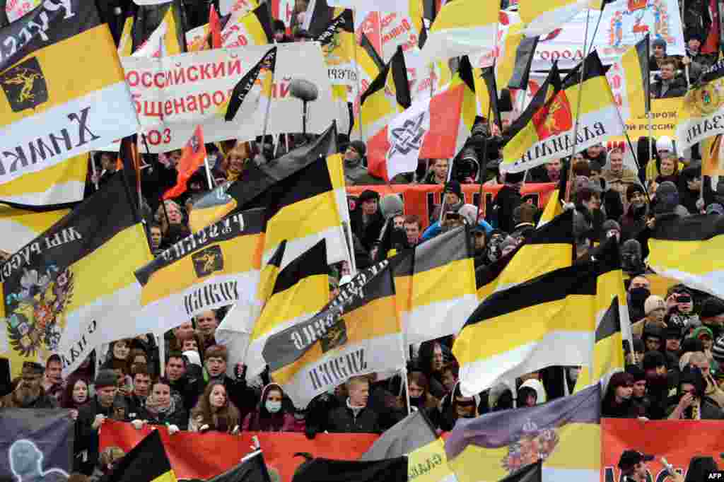 Russian ultranationalists wave the black-yellow-white flags of the Russian Empire.