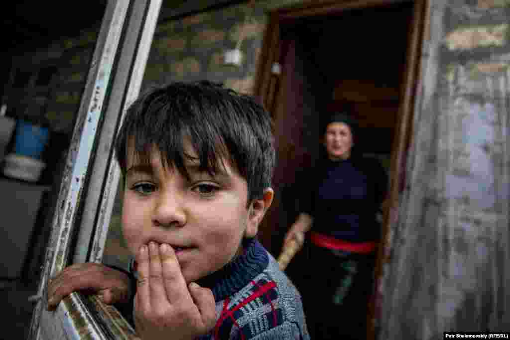 Adygezel, 5, at the entrance of the family home.