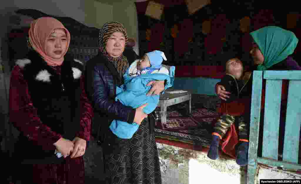 Aishe Gadir (C), the mother of Malik Yasyrov - a Dungan man, Kazakh language teacher who died from a gunshot wound in the Masanchi attacks - looks on during a feast held for the neighbours and relatives who helped bury him in the settlement of Sortobe - in southern Kazakhstan&#39;s Jambyl region by the border with Kyrgyzstan - on February 12, 2020.