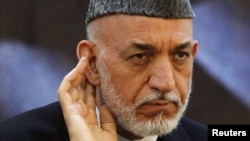 Afghan President Hamid Karzai said there were "foreign hands" behind the Taliban's new office.