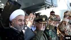 Iran -- A handout picture made available by the Iranian presidential official website shows Iranian President Hassan Rowhani (L) attending the navy parade during a military drill in the Oman Sea, port city Bandar Jask southern Iran, 31 December 2014.