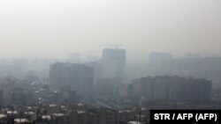 A general view taken from northern Tehran shows a blanket of smog covering the city as heavy pollution hit the Iranian capital on December 15, 2019.