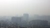 Iran -- A general view taken from northern Tehran shows a blanket of smog covering the city as heavy pollution hit the Iranian capital on December 15, 2019. (Photo by STR / AFP)