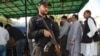 FILE: A Pakistani policeman stands guard outside the high court building in Islamabad.
