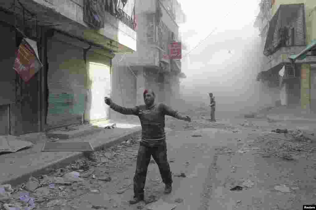 An injured man walks along a street after what activists said was a barrel bomb dropped by forces loyal to Syria&#39;s President Bashar al-Assad in Aleppo&#39;s al-Myassar neighbourhood on April 16. (Reuters/Firas Badawi)