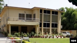 An exterior view of the sealed offices of the international charity Save The Children in Islamabad on June 12