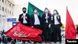 Young men wearing masks for protection from coronavirus celebrating the birth anniversary of the 2nd Imam of Shiites in Tehran, Iran. May 8, 2020.