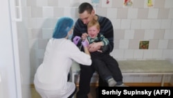 A child receives a vaccination in Ukraine, the country worst hit by Europe's measles epidemic.