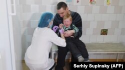 A child receives a vaccination in Ukraine, the country worst hit by Europe's measles epidemic.