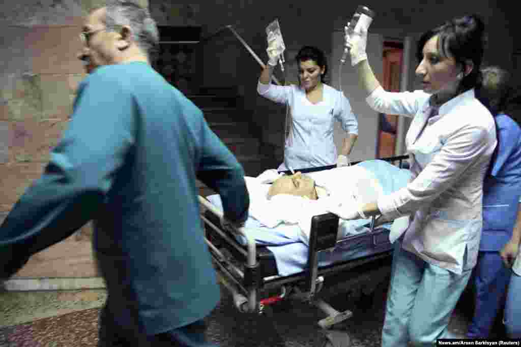 Armenian presidential candidate Paruyr Hairikian is wheeled by medical staff members at a hospital in Yerevan. Hairikian was wounded by unknown gunmen in the capital in an attack that could delay the February 18 election. Doctors treating Hairikian said he was in stable condition and the wound was not considered life-threatening. (Reuters/News.am/Arsen Sarkisyan)