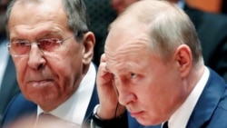 Russian President Vladimir Putin and Foreign Minister Sergei Lavrov listen during a Libya summit in Berlin on January 19.